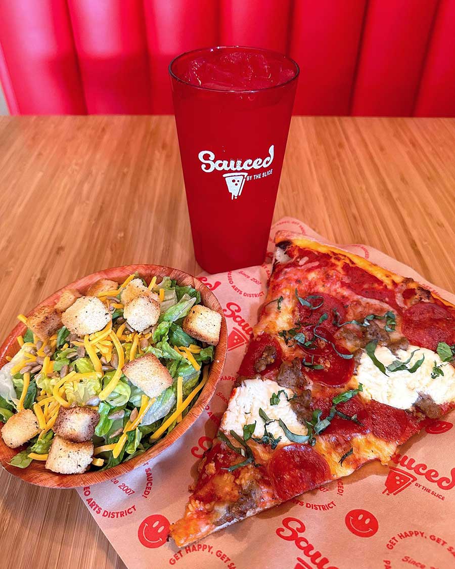 Pizza Salad and Drink on a Table in a Booth at Sauced